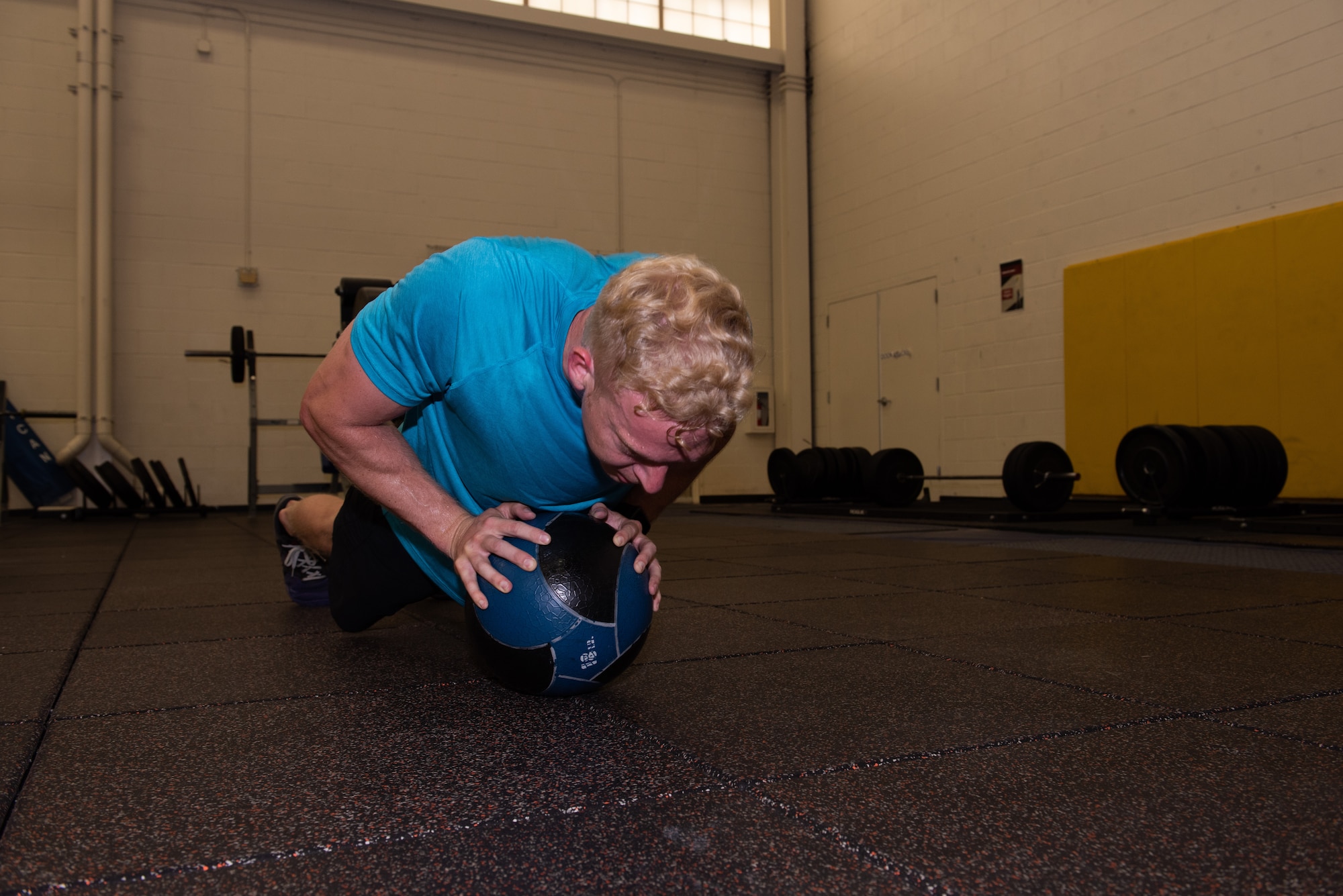U.S. Air Force Capt. Christopher Williston, a 21st Airlift Squadron C-17 Globemaster III pilot from Baton Rouge, Louisiana, performs push-ups on an 18-pound medicine ball during a workout June 13, 2019, at Travis Air Force Base, California. Williston is training to compete in the Alpha Warrior Western Regional Competition June 21 at Hill AFB, Utah. (U.S. Air Force photo by Tech. Sgt. James Hodgman)