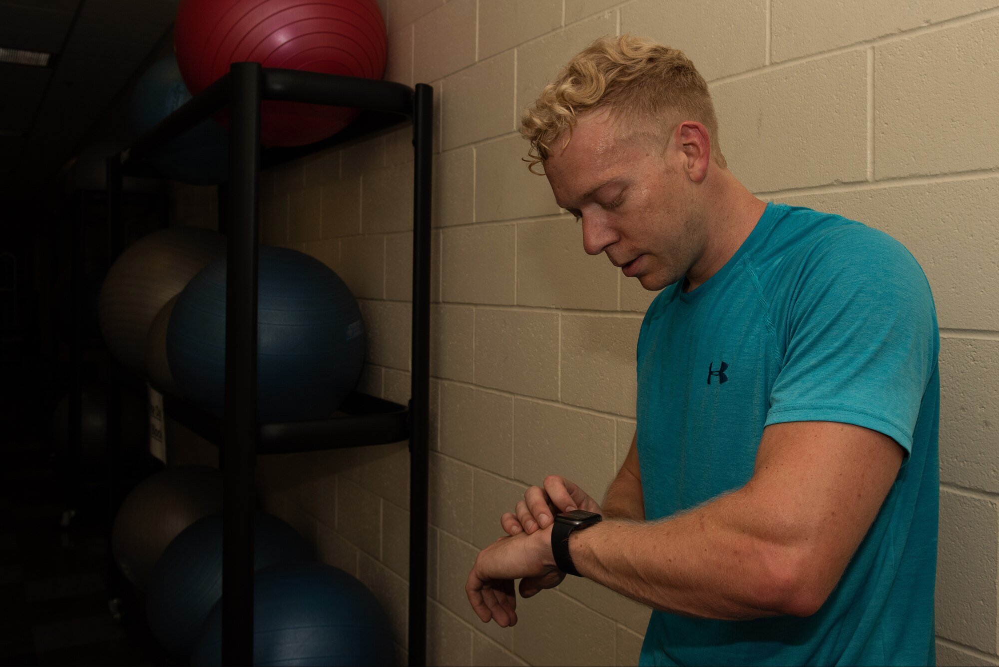 U.S. Air Force Capt. Christopher Williston, a 21st Airlift Squadron C-17 Globemaster III pilot from Baton Rouge, Louisiana, looks at his fitness tracker to see how many calories he’s burned during a workout June 13 at Travis Air Force Base, California. Williston is training to compete in the Alpha Warrior Western Regional Competition June 21 at Hill AFB, Utah. During the workout, Williston burned 746 calories. (U.S. Air Force photo by Tech. Sgt. James Hodgman)