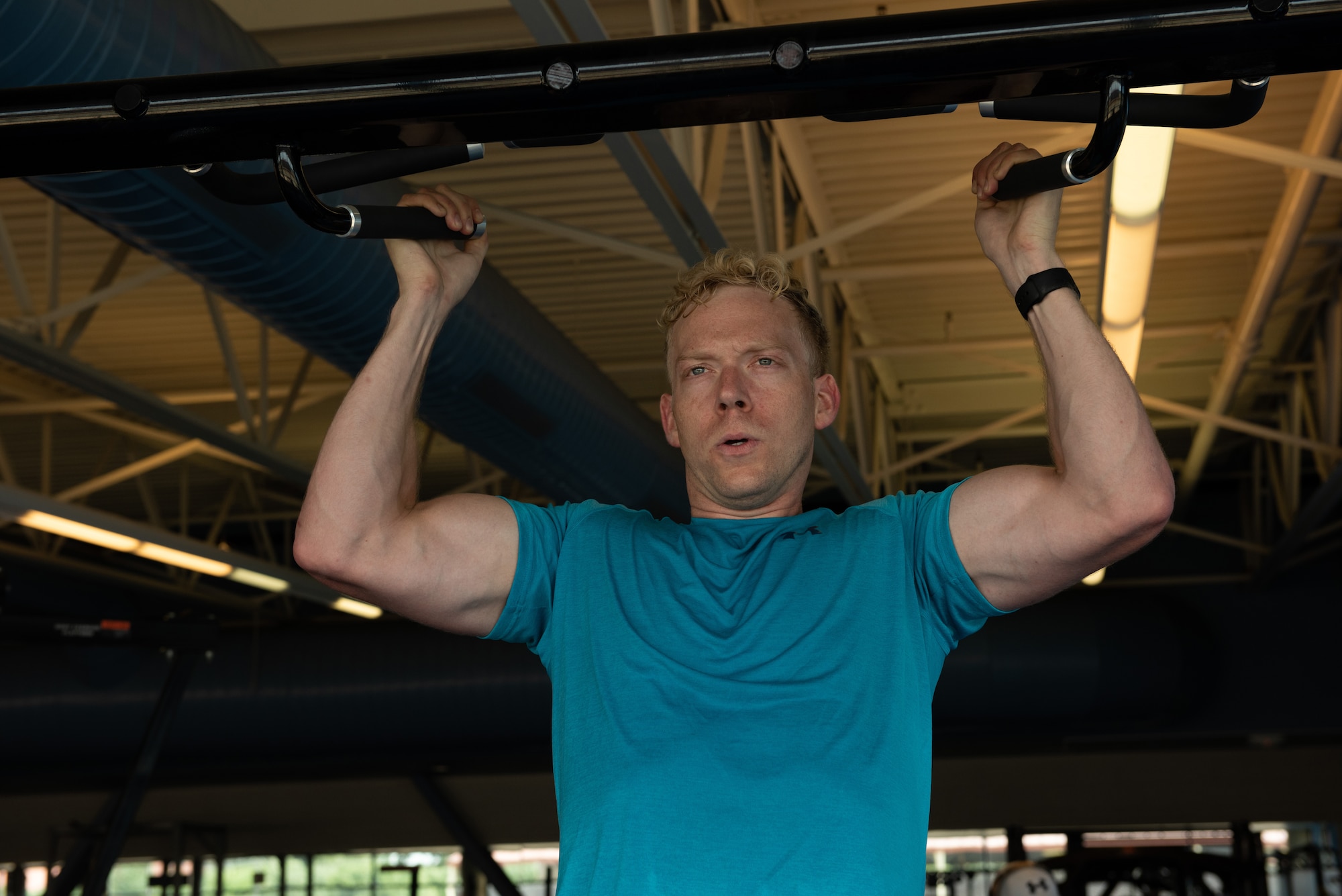 U.S. Air Force Capt. Christopher Williston, a 21st Airlift Squadron C-17 Globemaster III pilot from Baton Rouge, Louisiana, performs a pull up during a workout June 13, 2019, at Travis Air Force Base, California. Williston is training to compete in the Alpha Warrior Western Regional Competition June 21 at Hill AFB, Utah. (U.S. Air Force photo by Tech. Sgt. James Hodgman)