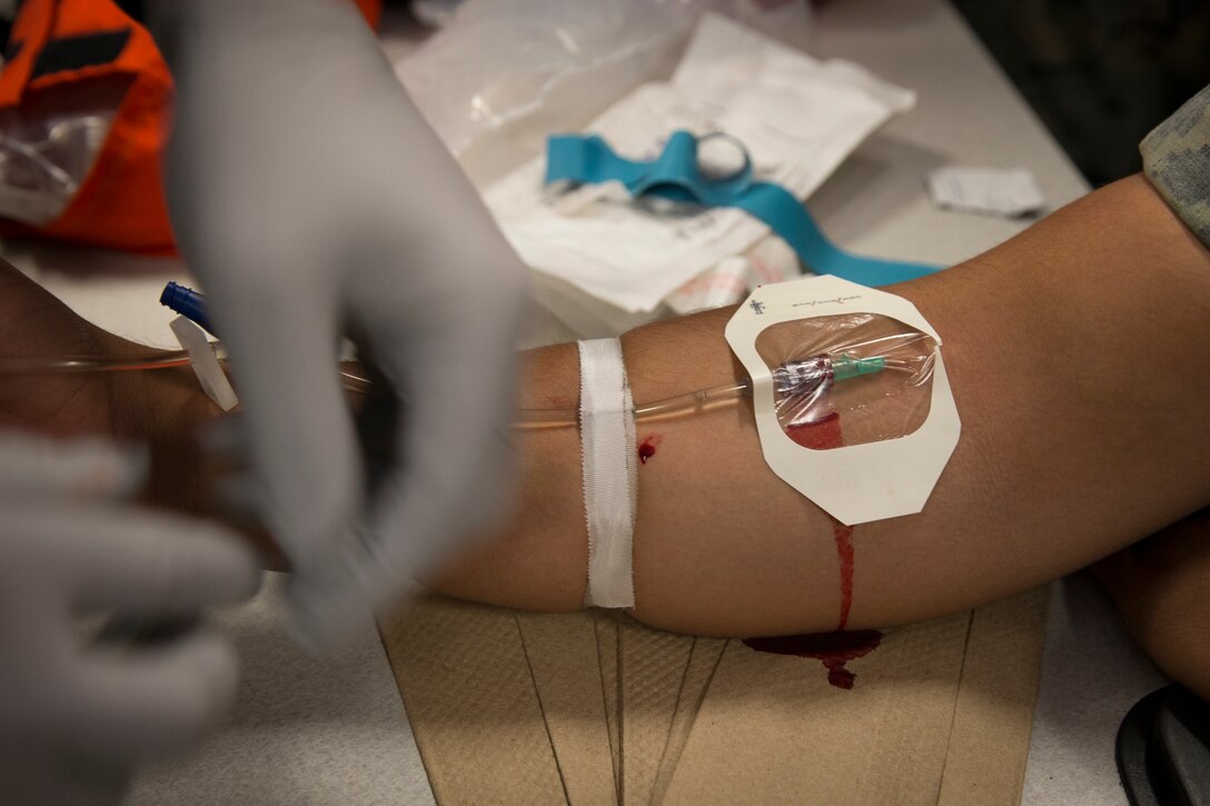 U.S. Navy Corpsman HM2 Max Sechler, Marine Corps Air Station Yuma Search and Rescue, demonstrates an IV lab for U.S. Marines following Combat Lifesaver (CLS) Course at MCAS Yuma Ariz., May 14, 2019. The CLS Course is a two-week long evaluation that teaches service members how to properly apply life-saving medical treatmemt to injured service members in any environment (U.S. Marine Corps photo by Lance Cpl. Joel Soriano)