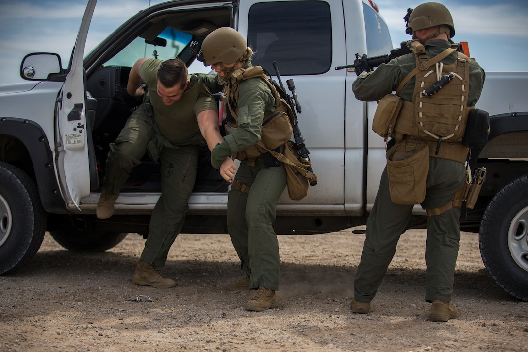 U.S. Marines with the Provost Marshal's Office, Headquarters and Headquarters Squadron, Marine Corps Air Station (MCAS) Yuma, conduct Special Reaction Team (SRT) vehicle assault training on MCAS Yuma, Ariz., May 16, 2019. The SRT is comprised of military police personnel trained to give an installation commander the ability to counter or contain a special threat situation surpassing normal law enforcement capabilities. (U.S. Marine Corps photo by Pfc. John Hall)