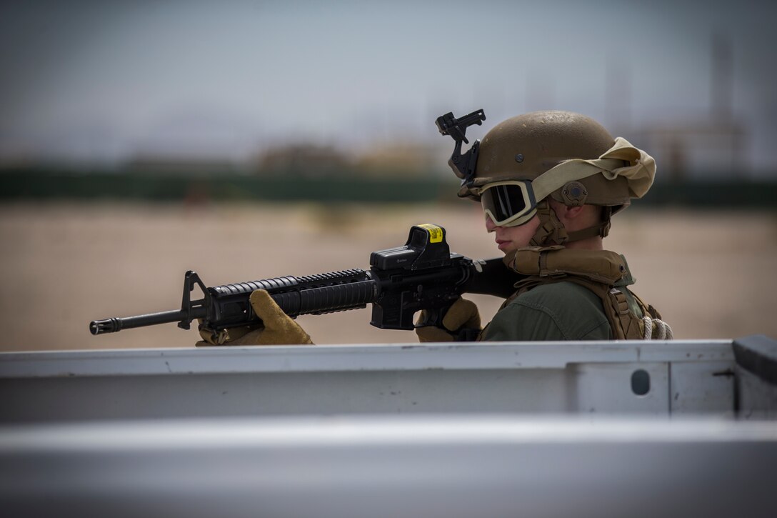 U.S. Marines with the Provost Marshal's Office, Headquarters and Headquarters Squadron, Marine Corps Air Station (MCAS) Yuma, conduct Special Reaction Team (SRT) vehicle assault training on MCAS Yuma, Ariz., May 16, 2019. The SRT is comprised of military police personnel trained to give an installation commander the ability to counter or contain a special threat situation surpassing normal law enforcement capabilities. (U.S. Marine Corps photo by Pfc. John Hall)