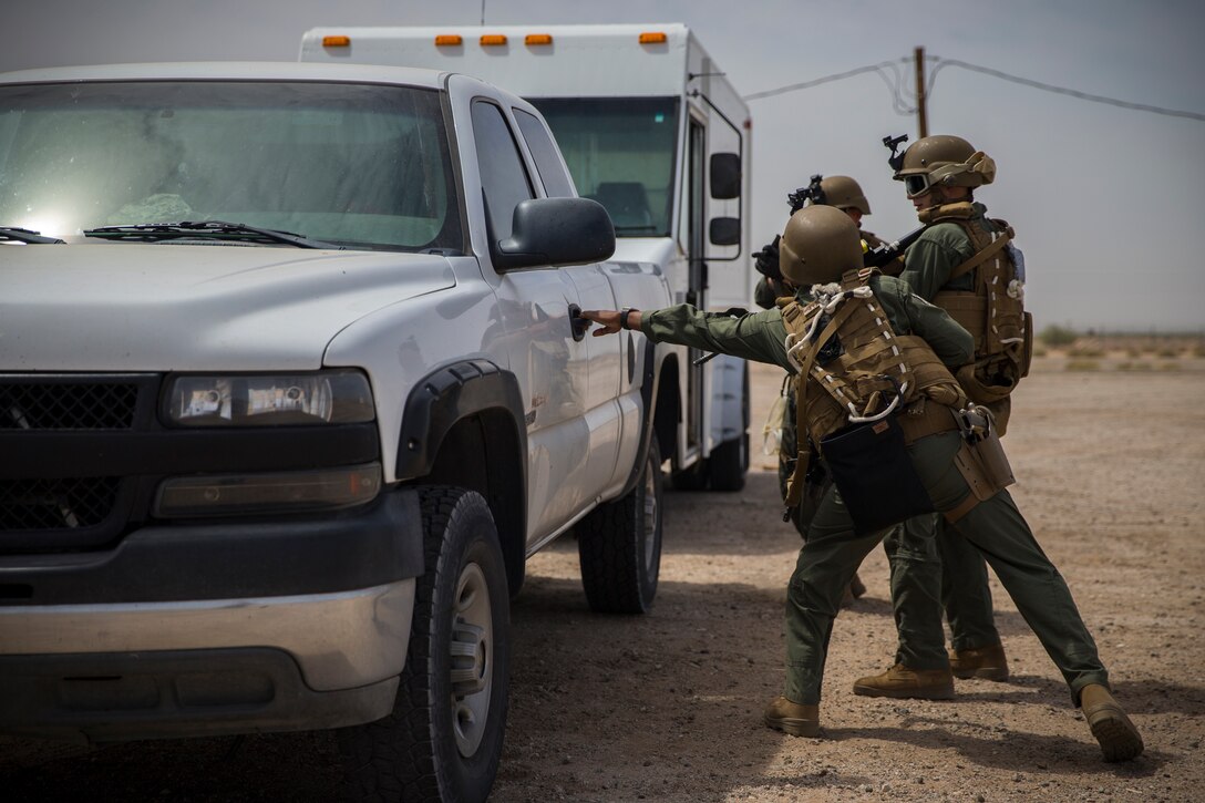 U.S. Marines with the Provost Marshal's Office, Headquarters and Headquarters Squadron, Marine Corps Air Station (MCAS) Yuma, conduct Special Reaction Team (SRT) vehicle assault training on MCAS Yuma, Ariz., May 16, 2019. The SRT is comprised of military police personnel trained to give an installation commander the ability to counter or contain a special threat situation surpassing normal law enforcement capabilities. (U.S. Marine Corps photo by Pfc. John Hall)