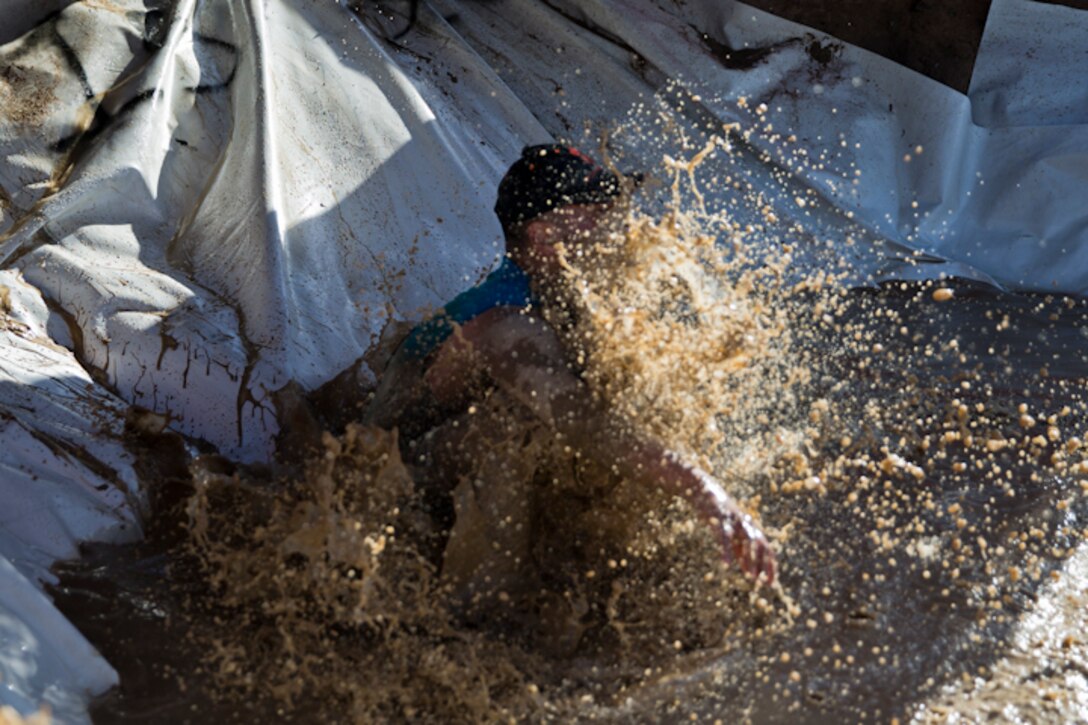 U.S. Marines, Sailors, and Civilians participate in the Marine Corps Air Station (MCAS) Yuma Mud Run at MCAS Yuma Ariz., May 18, 2019. The Mud Run consisted of various obstacles for all of the participants in both the competitive and non-competitive events. (U.S. Marine Corps photo by Lance Cpl. Joel Soriano)