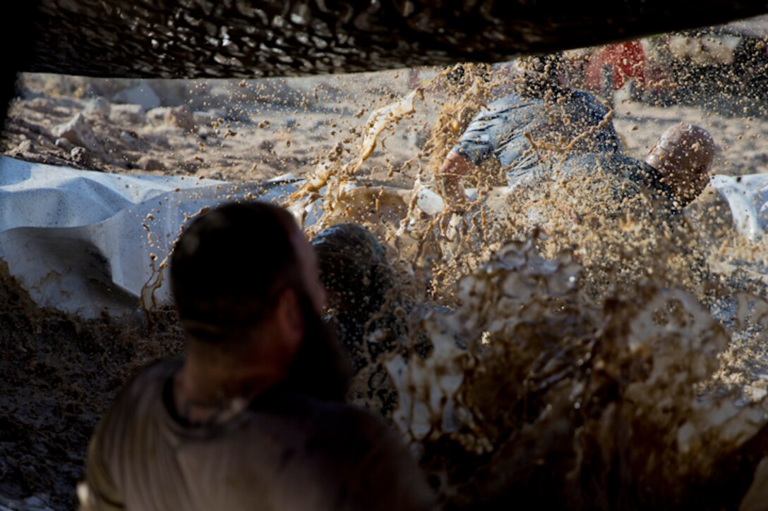 U.S. Marines, Sailors, and Civilians participate in the Marine Corps Air Station (MCAS) Yuma Mud Run at MCAS Yuma Ariz., May 18, 2019. The Mud Run consisted of various obstacles for all of the participants in both the competitive and non-competitive events. (U.S. Marine Corps photo by Lance Cpl. Joel Soriano)