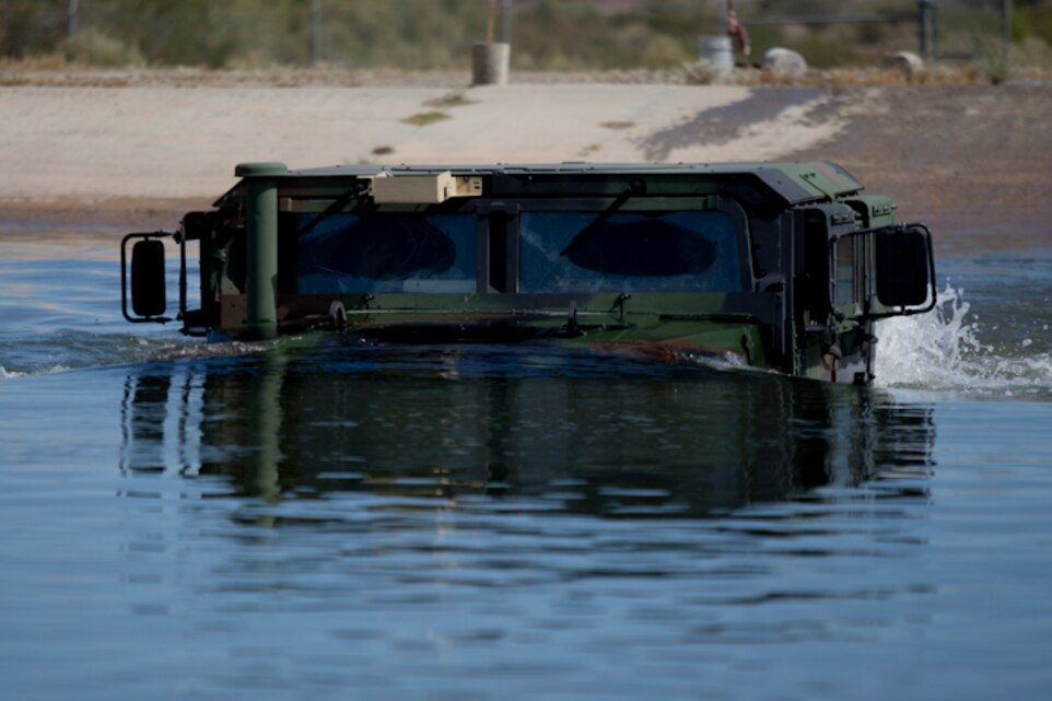 U.S. Marines with Marine Wing Support Squadron (MWSS) 371 participate in a Mud and Fording Course at Cibola Lake Mud course and Fording Basin, Yuma Proving Grounds Ariz., May 21, 2019. The mission of the MWSS-371 Mud and Fording Course is to enhance motor vehicle proficiency while in a wet and humid environment. (U.S. Marine Corps photo by Lance Cpl. Joel Soriano)