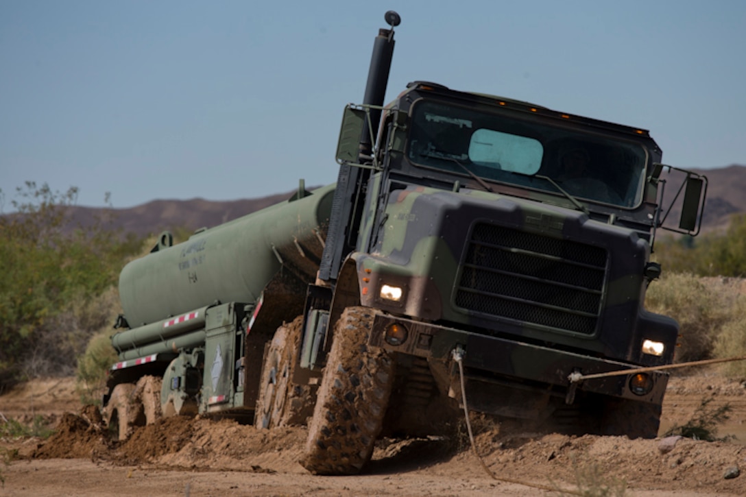 U.S. Marines with Marine Wing Support Squadron (MWSS) 371 participate in a Mud and Fording Course at Cibola Lake Mud course and Fording Basin, Yuma Proving Grounds Ariz., May 21, 2019. The mission of the MWSS-371 Mud and Fording Course is to enhance motor vehicle proficiency while in a wet and humid environment. (U.S. Marine Corps photo by Lance Cpl. Joel Soriano)