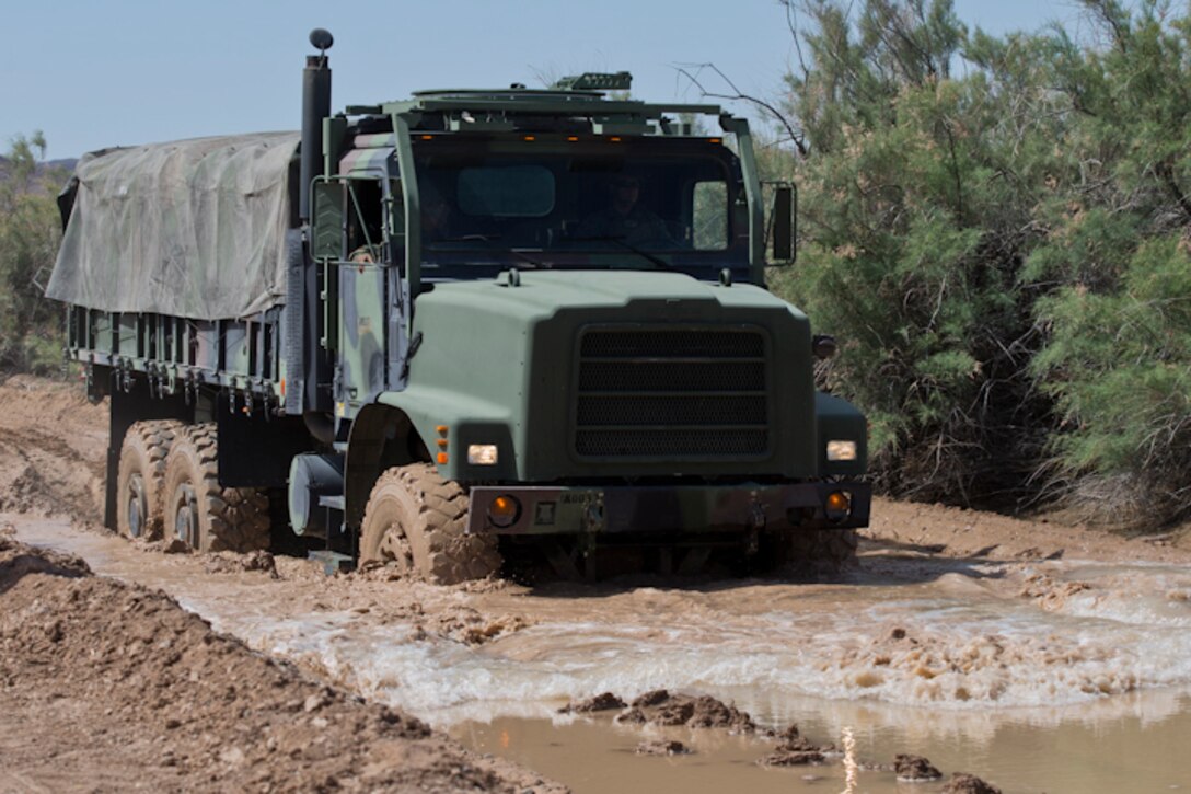 U.S. Marines with Marine Wing Support Squadron (MWSS) 371 participate in a Mud and Fording Course at Cibola Lake Mud course and Fording Basin, Yuma Proving Grounds Ariz., May 21, 2019. The mission of the MWSS-371 Mud and Fording Course is to enhance motor vehicle proficiency while in a wet and humid environment. (U.S. Marine Corps photo by Lance Cpl. Joel Soriano)