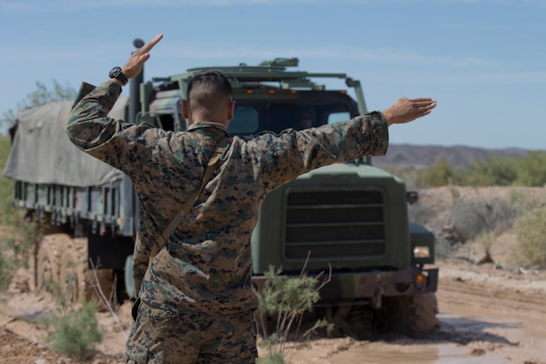 U.S. Marines with Marine Wing Support Squadron (MWSS) 371 participate in a Mud and Fording Course at Cibola Lake Mud course and Fording Basin, Yuma Proving Grounds Ariz., May 21, 2019. The mission of the MWSS-371 Mud and Fording Course is to enhance motor vehicle proficiency while in a wet and humid environment. (U.S. Marine Corps photo by Lance Cpl. Joel Soriano)