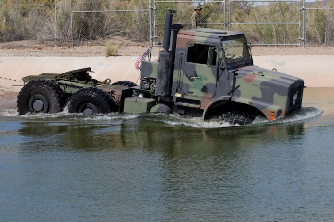 U.S. Marines with Marine Wing Support Squadron (MWSS) 371 participate in a Mud and Fording Course at Cibola Lake Mud course and Fording Basin, Yuma Proving Grounds Ariz., May 21, 2019. The mission of the MWSS-371 Mud and Fording Course is to enhance motor vehicle proficiency while in a wet and humid environment. (U.S. Marine Corps photo by Lance Cpl. Joel Soriano)