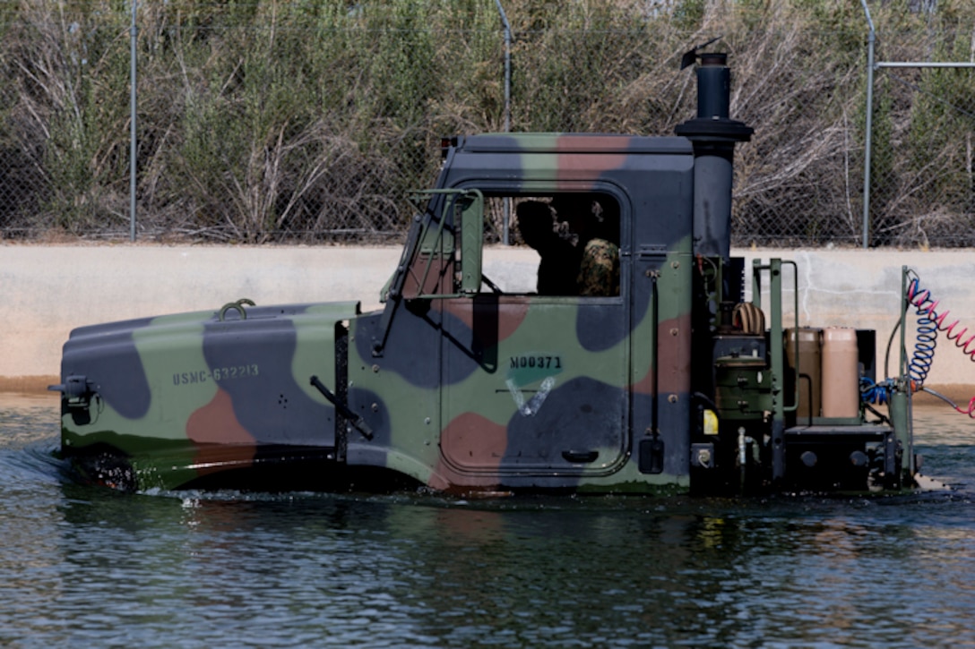 U.S. Marines with Marine Wing Support Squadron (MWSS) 371 participate in a Mud and Fording Course at Cibola Lake Mud course and Fording Basin, Yuma Proving Grounds Ariz., May 21, 2019. The mission of the MWSS-371 Mud and Fording Course is to enhance motor vehicle proficiency while in a wet and humid environment. (U.S. Marine Corps photo by Lance Cpl. Joel Soriano)
