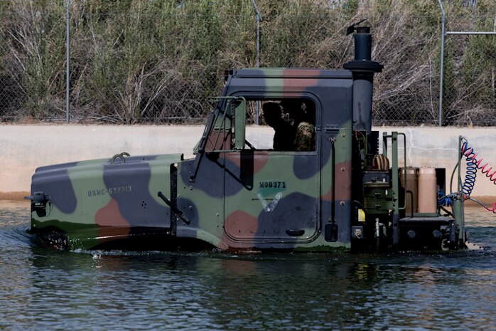 U.S. Marines with Marine Wing Support Squadron (MWSS) 371 participate in a Mud and Fording Course at Cibola Lake Mud course and Fording Basin, Yuma Proving Grounds Ariz., May 21, 2019. The mission of the MWSS-371 Mud and Fording Course is to enhance motor vehicle proficiency while in a wet and humid environment. (U.S. Marine Corps photo by Lance Cpl. Joel Soriano)