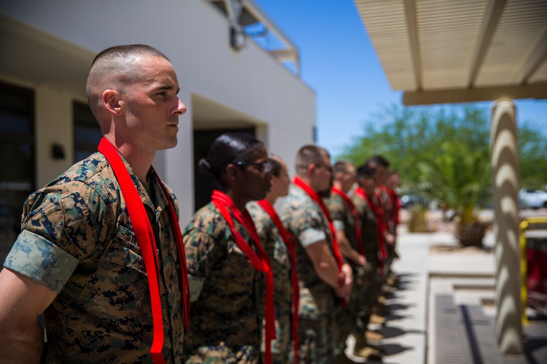 U.S. Marines assigned to Marine Corps Air Station (MCAS) Yuma Headquarters & Headquarters Squadron (H&HS) receive their blood stripes during a Blood Stripe Ceremony at MCAS Yuma Ariz., June 4, 2019. The blood stripe honors the blood that was shed by Marine officers and noncommissioned officers (NCO) during the Battle of Chapultepec in 1847 and is worn on the trousers of the NCOs, Staff NCOs, and officers in remembrance of those who courageously fought in the battle. (U.S. Marine Corps photo by Lance Cpl. John Hall)