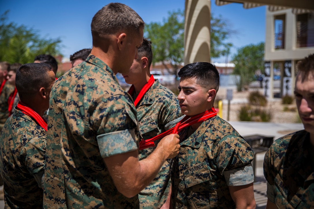 U.S. Marines assigned to Marine Corps Air Station (MCAS) Yuma Headquarters & Headquarters Squadron (H&HS) receive their blood stripes during a Blood Stripe Ceremony at MCAS Yuma Ariz., June 4, 2019. The blood stripe honors the blood that was shed by Marine officers and noncommissioned officers (NCO) during the Battle of Chapultepec in 1847 and is worn on the trousers of the NCOs, Staff NCOs, and officers in remembrance of those who courageously fought in the battle. (U.S. Marine Corps photo by Lance Cpl. John Hall)