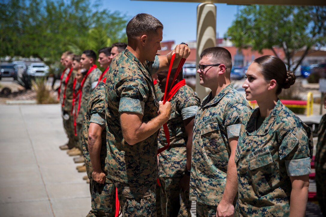 U.S. Marines assigned to Marine Corps Air Station (MCAS) Yuma Headquarters & Headquarters Squadron (H&HS) receive their blood stripes during a Blood Stripe Ceremony at MCAS Yuma Ariz., June 4, 2019. The blood stripe honors the blood that was shed by Marine officers and noncommissioned officers (NCO) during the Battle of Chapultepec in 1847 and is worn on the trousers of the NCOs, Staff NCOs, and officers in remembrance of those who courageously fought in the battle. (U.S. Marine Corps photo by Lance Cpl. John Hall)