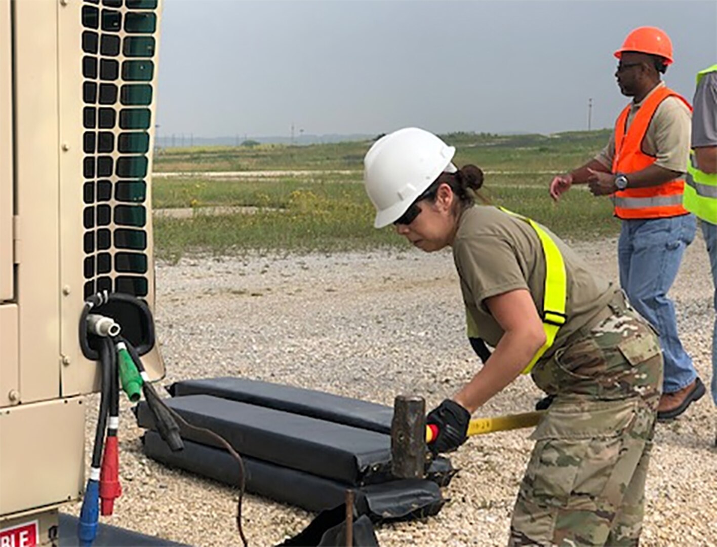 U.S. Army Sgt. Diana Palomino, of Disposition Services Unit 1 out of Joint Base Lewis-McChord, hammers in a stabilization stake while preparing a mobile property disposal site at Camp Bondsteel in Kosovo.
