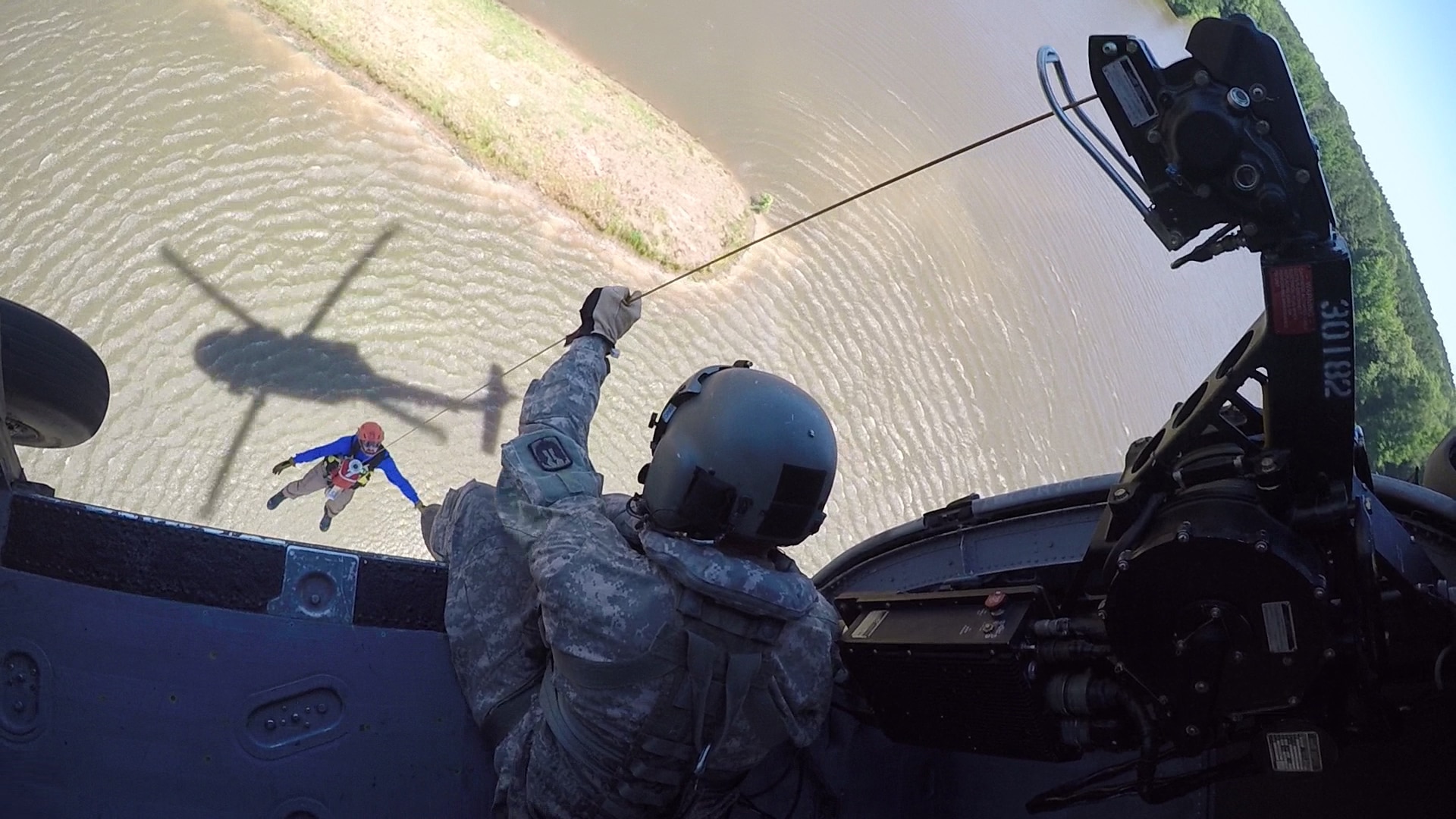 Sgt. Stephen Koiner, crew chief, with Company B, 1st Battalion 185th Aviation Regiment lowers a member of Mississippi Task Force 2 from a UH-60 during over-water roof top rescue training May 31, 2019 at Camp McCain, Mississippi during exercise Ardent Sentry. Ardent Sentry 2019 is a North American Aerospace Defense Command and U.S. Northern Command exercise focused on defense support of civil authorities during a simulated New Madrid Seismic Zone earthquake conducted to strengthen Mississippi’s response to natural disasters. (Mississippi National Guard Photo by Sgt. Shawn Keeton/RELEASED)