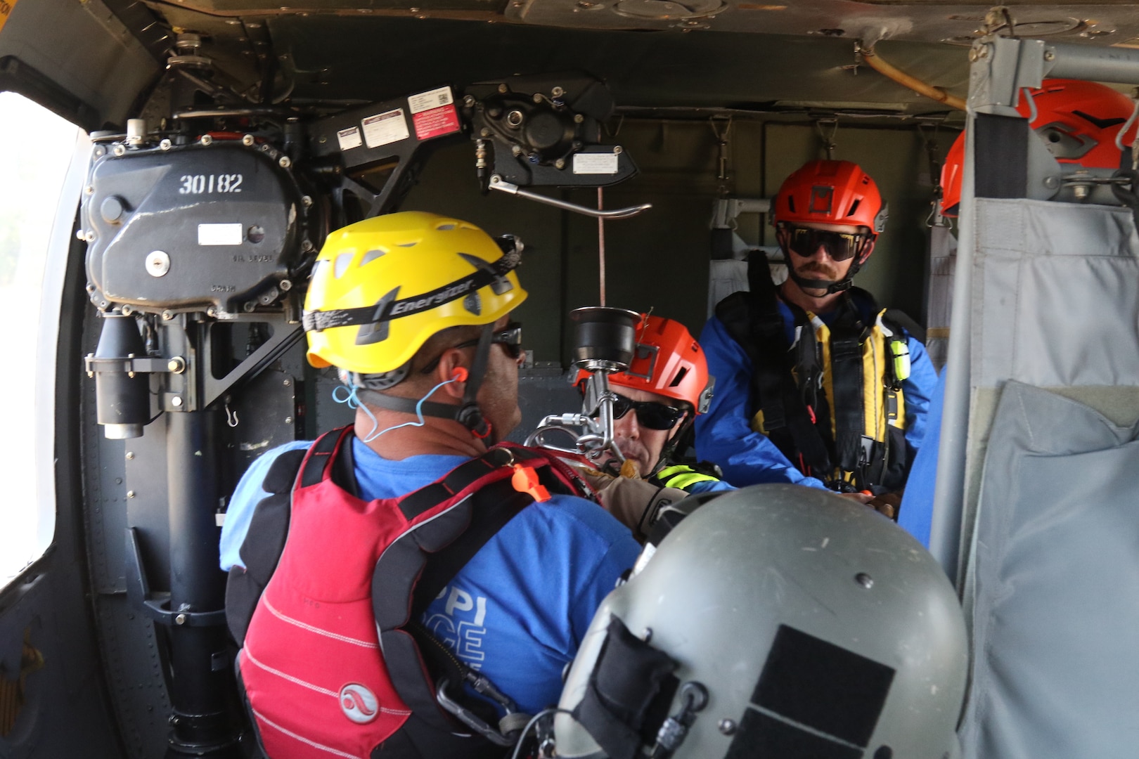 Members of the Mississippi Task Force Urban Search and Rescue team are harnessed to a hoist before being lowered from a helicopter during rooftop rescue training May 31, 2019 at Camp McCain, Mississippi. The joint training between the civilian task force and the military was part of Ardent Sentry 2019, an exercise training Mississippians to help Mississippians in times of crisis and be ready to assist in recovery efforts. (U.S. Army National Guard photo by PFC Austin Eldridge/RELEASED)