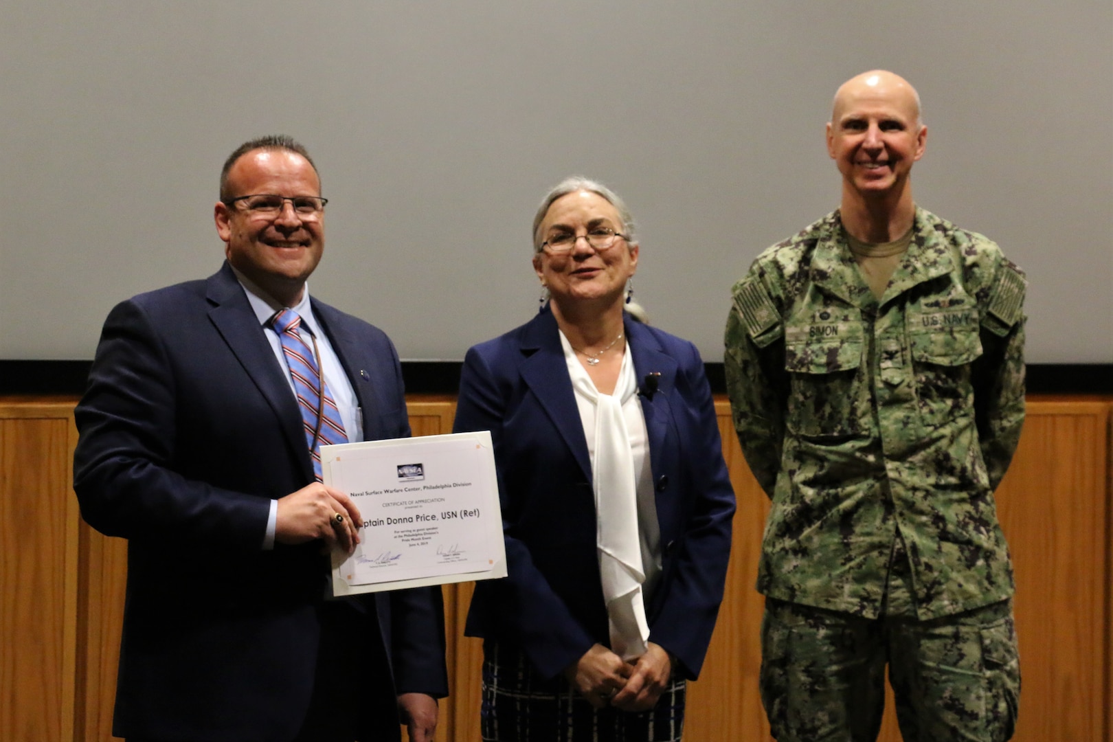 Philadelphia (June 4, 2019) Naval Surface Warfare Center, Philadelphia Division (NSWCPD) hosted keynote speaker Capt. Donna Price, United States Navy, (retired) during the Command’s annual Lesbian, Gay, Bisexual, Transgender (LGBT) Pride Month event on June 4. Price (middle) accepted a Certificate of Appreciation from NSWCPD’s Technical Director Mr. Tom Perotti (left) and NSWCPD’s Commanding Officer Capt. Dana F. Simon (right). (U.S. Navy photo by Kirsten St. Peter)/Released