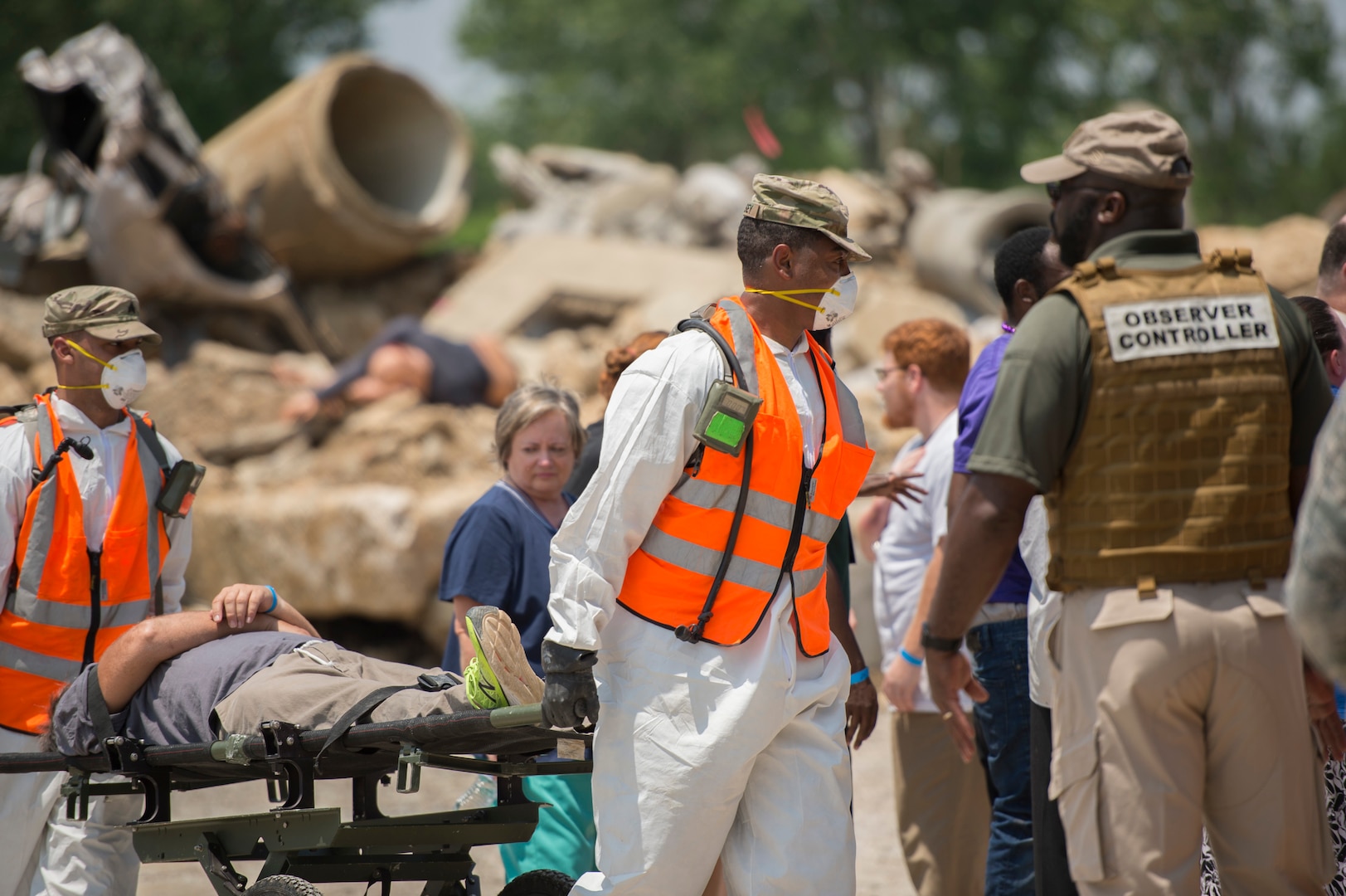 Georgia National Guard soldiers bring a role player to the decontamination tent during FEMA exercise Shaken Fury 2019 on June 5 in Millington, Tenn. Forty-four medical and communications personnel with the 116th Air Control Wing, Georgia Air National Guard, served on the CBRNE Enhanced Response Force working alongside more than 200 Georgia National Guard soldiers, testing the synergy necessary to support the community during natural disasters like the simulated earthquake in the exercise. (U.S. Air National Guard photo by Tech. Sgt. Nancy Goldberger/RELEASED)