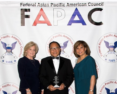 Hunstville, Ala. (May 16, 2019) Naval Surface Warfare Center, Philadelphia Division (NSWCPD) employee Kim Yee was recognized with the 2019 Federal Asian Pacific American Council (FAPAC) Excellence in Individual Achievement, GS 13-15 Category award for his efforts in promoting diversity and for his leadership. Yee (middle) accepted the award from Jody Singer, Director of NASA Marshall Space Flight Center (left) and Olivia Adrian, president of FAPAC (right). (Photo courtesy of Thong Vu, FAPAC)