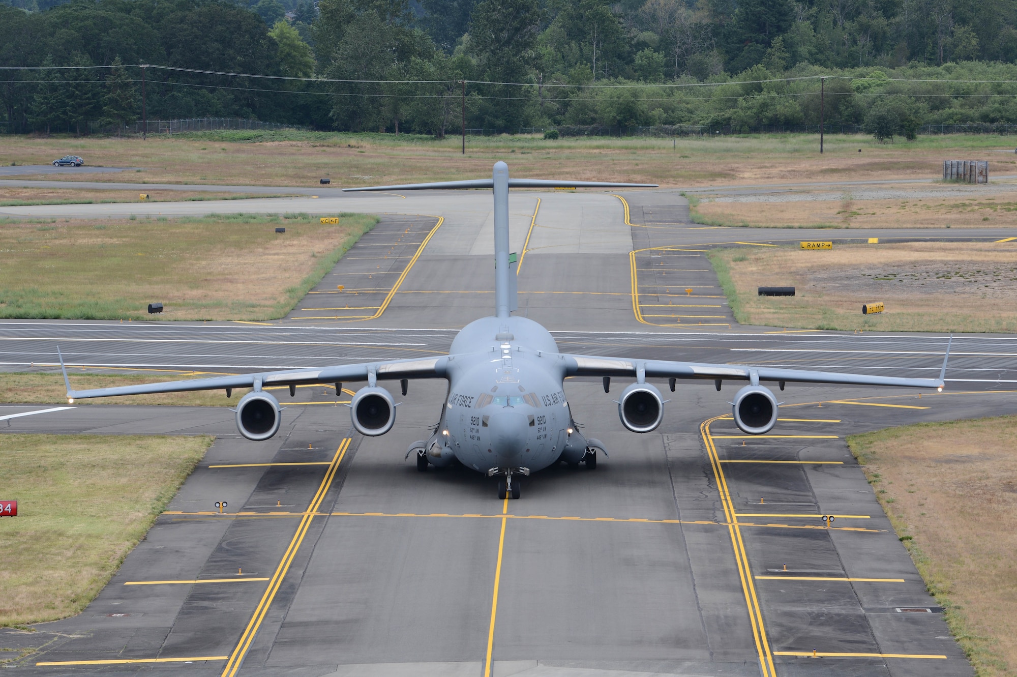 The first aircraft to land on the newly resurfaced runway taxis to its parking spot June 17, 2019 at Joint Base Lewis-McChord, Wash. McChord Field aircraft and Airmen were relocated to other west coast bases while the runway was resurfaced. (U.S. Air Force photo by Airman 1st Class Sara Hoerichs)