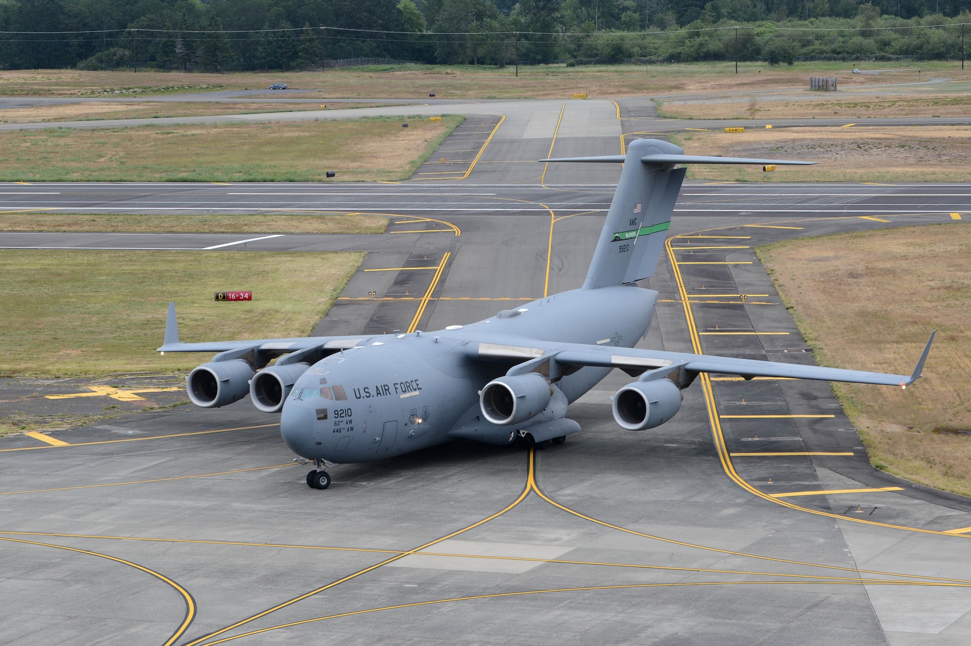 The first aircraft to land on the newly resurfaced runway taxis to its parking spot June 17, 2019 at Joint Base Lewis-McChord, Wash. McChord Field aircraft and Airmen were relocated to other west coast bases while the runway was resurfaced. (U.S. Air Force photo by Airman 1st Class Sara Hoerichs)