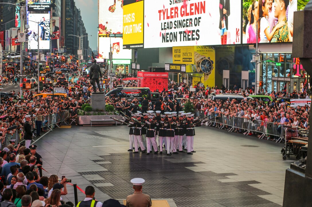 Marines with the U.S. Marine Corps Silent Drill Platoon execute their “bursting bomb” sequence during their performance as a part of a Battle Color Ceremony for New York Fleet Week at Times Square, Manhattan, NY, May 27, 2018. Fleet Week New York is an opportunity for the American public to meet their Marine Corps, Navy and Coast Guard teams and experience America’s sea services.