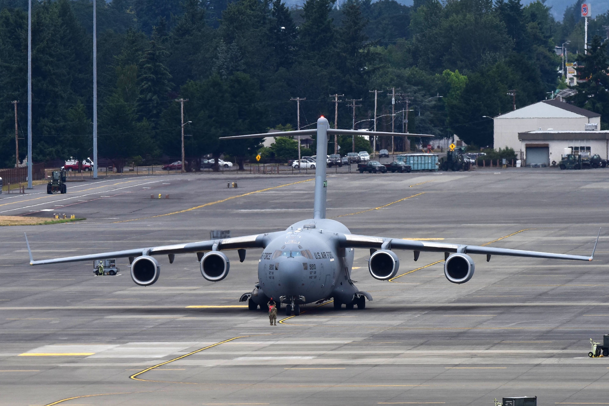 62nd Aircraft Maintenance Squadron Airmen marshal the first returning aircraft to its parking spot at McChord Field, June 17, 2019, at Joint Base Lewis-McChord. McChord Field aircraft and Airmen were relocated to other west coast bases while the runway was resurfaced. (U.S. Air Force photo by Airman 1st Class Sara Hoerichs)