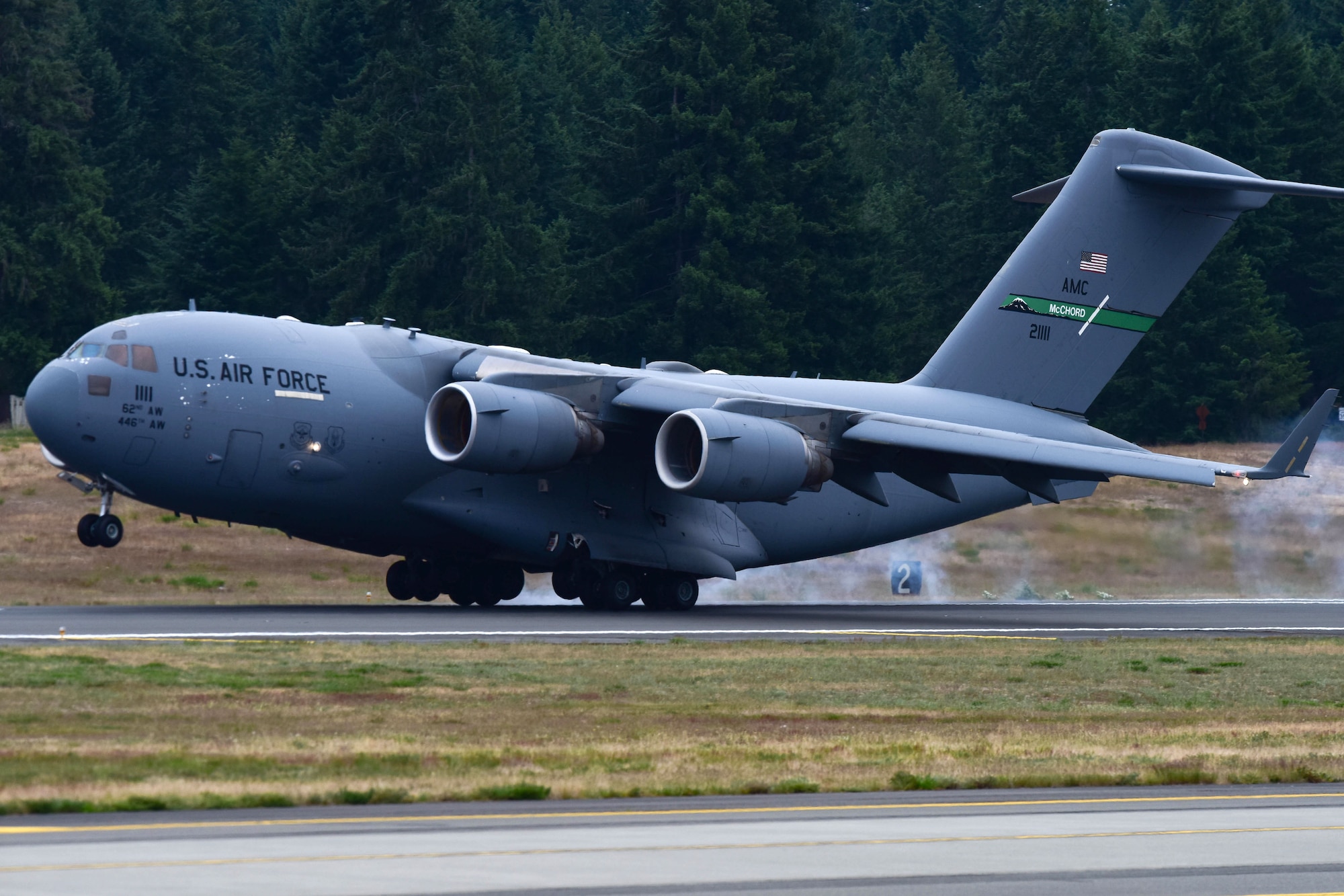 The first aircraft lands on the newly resurfaced runway at McChord Field, June 17, 2019, at Joint Base Lewis-McChord. McChord Field aircraft and Airmen continued operations at other west coast bases while the runway was resurfaced.  (U.S. Air Force photo by Airman 1st Class Sara Hoerichs)