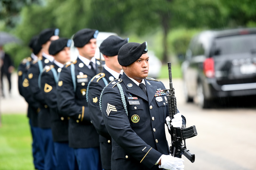 Soldiers assigned to the 101st Airborne Division render a salute with their weapons during the graveside service of Staff Sgt. Al Mampre at Memorial Park Cemetery in Skokie on Saturday, June 15, 2019.