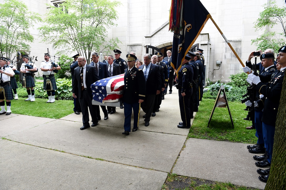 Pallbearers carry the casket of Staff Sgt. Al Mampre to a waiting hearse following a funeral service on Saturday, June 15, 2019, at St. Luke's Episcopal Church in Evanston.