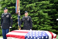 Soldiers assigned to the 101st Airborne Division stand over a casket during the graveside service of Staff Sgt. Al Mampre at Memorial Park Cemetery in Skokie on Saturday, June 15, 2019.