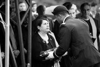 A Soldier assigned to the 101st Airborne Division presents a folded American flag to Virginia Mampre, the daughter of Staff Sgt. Al Mampre, during graveside services at Memorial Park Cemetery in Skokie on Saturday, June 15, 2019.