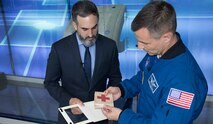 U.S. Army Col. Andrew Morgan receives a combat brassard, a World War II artifact, from Paul Morando, chief, Exhibits Division for the National Museum of the U.S. Army, May 30, 2019. The artifact will be flown to the International Space Station for Morgan's mission and will be returned to the Museum upon his return in Spring 2020. (Courtesy photo Anthony McKinney, Defense Media Activity)