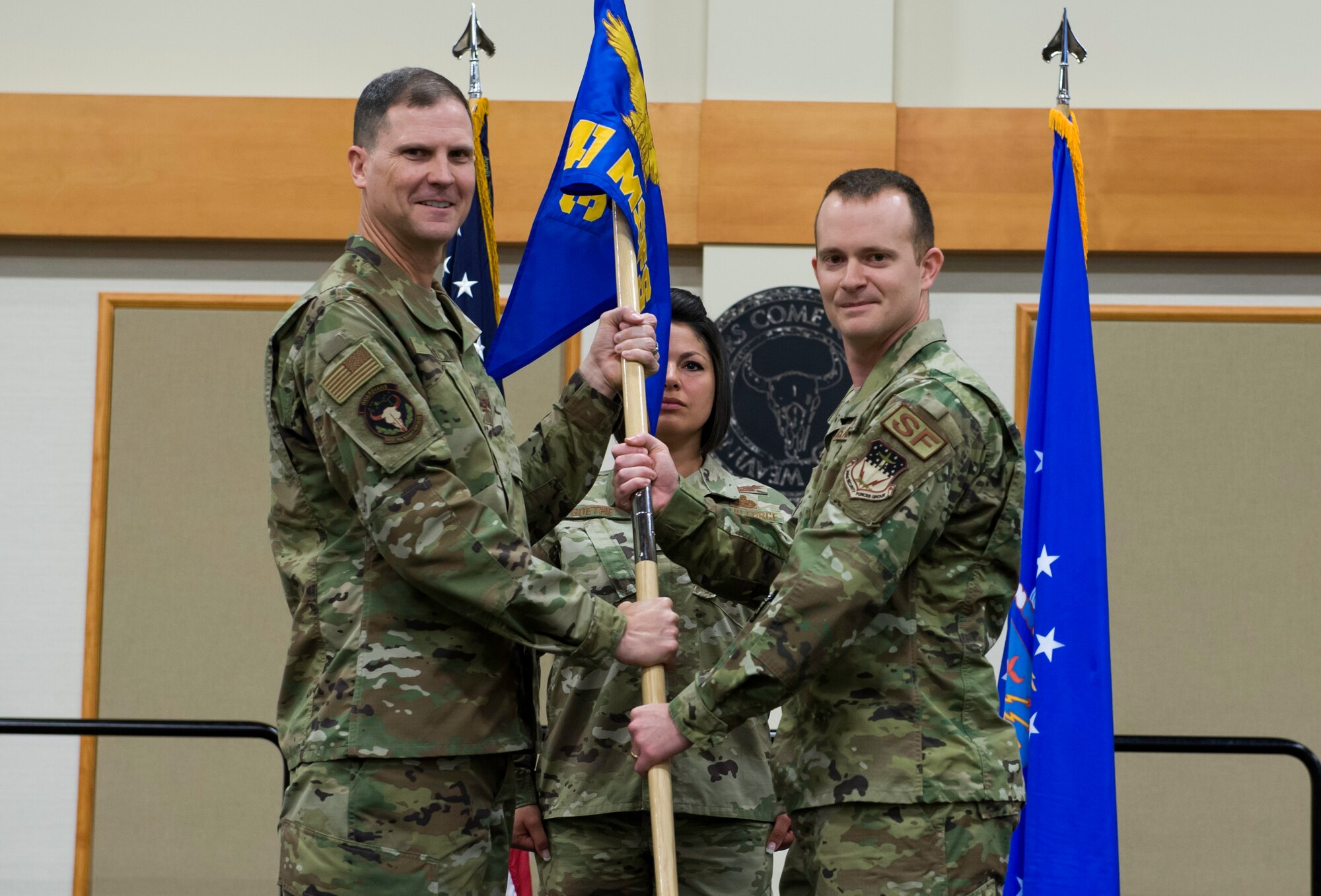 Capt. Daniel Evans, right, accepts command of the 841st Missile Security Forces Squadron from Col. Aaron Guill, 341st Security Forces Group commander, during a change of command ceremony June 18, 2019, at the Grizzly Bend on Malmstrom Air Force Base, Mont.