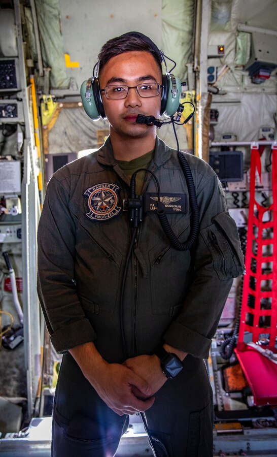 U.S. Marine Corps Lance Cpl. Frank DeGuzman, a crewmaster with Marine Aerial Refueler Transport Squadron 234, Marine Aircraft Group 41, 4th Marine Aircraft Wing, poses for a photo before an aerial refueling training mission at Canadian Forces Base Cold Lake, Canada, June 17, 2019, in support of Sentinel Edge 19. MARFORRES squadrons participate in SE19 to both complete annual training requirements and to increase unit readiness and proficiency. (U.S. Marine Corps photo by Sgt. Andy O. Martinez)