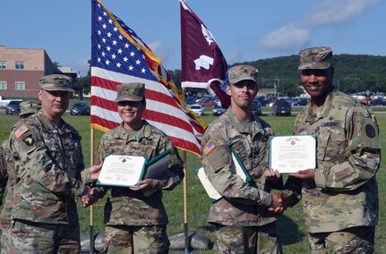 Army Col. Joseph Novack, deputy commander for medical services, and Command Sgt. Maj. Thomas Oates present Army Commendation Medals to Army Sgt. Samantha Delgado and Army Sgt. Kevin Ramirez during the Brooke Army Medical Center Best Medic Competition award ceremony at Joint Base San Antonio-Camp Bullis June 14. Delgado and Ramirez won the competition and will go on to represent BAMC in the Regional Health Command-Central competition later this year.