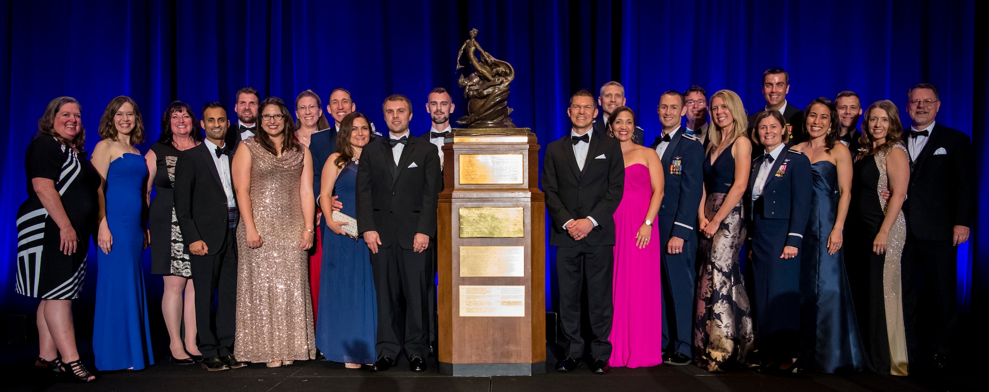 Team Edwards poses for a picture next the Collier Trophy after the 2018 Robert J. Collier Trophy presentation ceremony, Washington, June 13, 2019. The Collier Trophy is awarded annually by the U.S. Aeronautic Association "for the greatest achievement in aeronautics or astronautics in America, with respect to improving the performance, efficiency, and safety of air or space vehicles, the value of which has been thoroughly demonstrated by actual use during the preceding year."(U.S. Air Force photo by Christopher Dyer)
