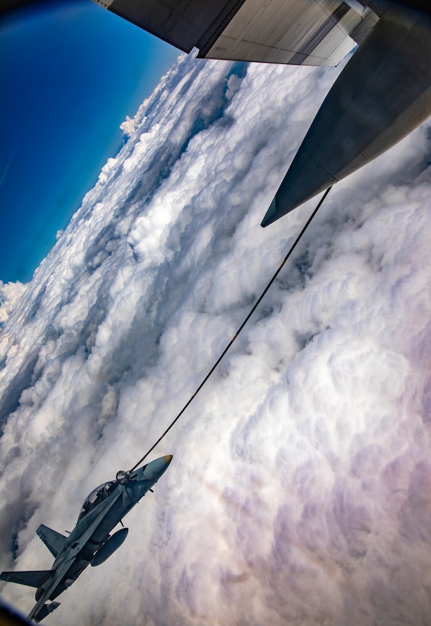 A Royal Canadian Air Force CF-188 Hornet from 409 Tactical Fighter Squadron, Canadian Forces Base Cold Lake is aerial refueled by a KC-130 Hercules from Marine Aerial Refueler Transport Squadron 234, Marine Aircraft Group 41, 4th Marine Aircraft Wing, during an aerial refueling training mission in the air over Cold Lake, Canada, June 17, 2019, in support of Sentinel Edge 19. MARFORRES squadrons participate in SE19 to both complete annual training requirements and to increase unit readiness and proficiency. (U.S. Marine Corps photo by Sgt. Andy O. Martinez)