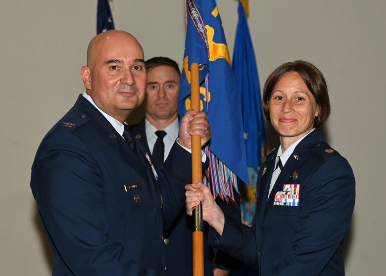 U.S. Air Force Col. Robert Ramirez, 17th Training Wing vice commander, presents the guidon to Maj. Kara Taylor, incoming 17th Comptroller Squadron commander, during the change of command ceremony at the event center on Goodfellow Air Force Base, Texas, June 18, 2019. Taylor has over fourteen years of financial management experience at the base, major command and headquarters levels. (U.S. Air Force photo by Airman 1st Class Robyn Hunsinger/Released)