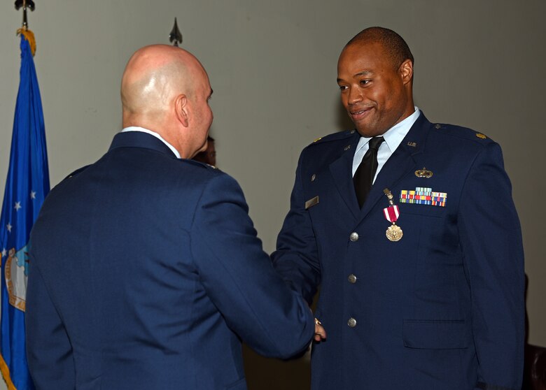 U.S. Air Force Col. Robert Ramirez, 17th Training Wing vice commander, presents Maj. Nelson Mitchell, 17th Comptroller Squadron outgoing commander, the Air Force Commendation Medal during the change of command ceremony at the event center on Goodfellow Air Force Base, Texas, June 18, 2019. As commander of the 17th CPTS, Mitchell was the chief finance officer and advisor to 16 wing, group, and squadron commanders on all budgeting, accounting, cost, non-appropriated funds, auditing, and banking matters. (U.S. Air Force photo by Airman 1st Class Robyn Hunsinger/Released)
