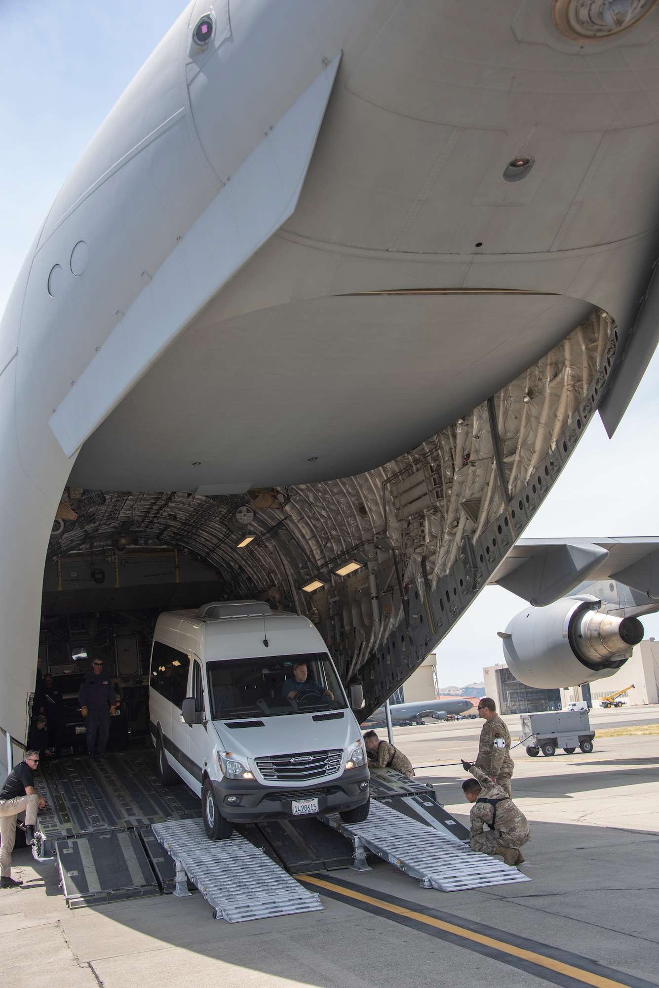60th Aerial Port Squadron personnel guide a California Urban Search and Rescue Task Force 7 emergency response vehicle into the cargo bay of a C-17 Globemaster III during a joint inspection and logistics drill June 13, 2019 at Travis Air Force Base, California. The annual training helps members of CA TF-7 learn about the process, governing and directives and ensures cargo is safe before loading onto an aircraft.  (U.S. Air Force photo by Heide Couch)