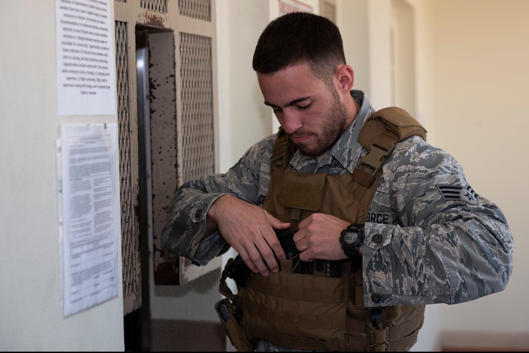 Senior Airman Todd Crivello, 60th Security Forces Squadron installation patrolman, secures his ammunition after receiving it from the armory June 18, 2019, at Travis Air Force Base, California. Security Forces Airmen like Crivello are responsible for protecting resources and personnel for the Air Force’s largest air mobility wing. (U.S. Air Force photo by Tech. Sgt. James Hodgman)