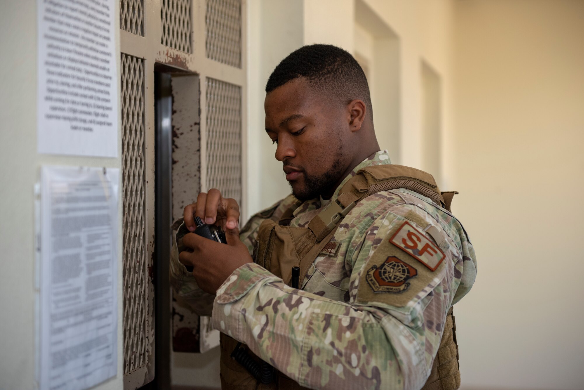 Senior Airman Kelly Goodwin, 60th Security Forces Squadron installation patrolman, checks his radio after receiving it from the armory June 18, 2019, at Travis Air Force Base, California. Security Forces Airmen like Goodwin are responsible for protecting resources and personnel for the Air Force’s largest air mobility wing. (U.S. Air Force photo by Tech. Sgt. James Hodgman)
