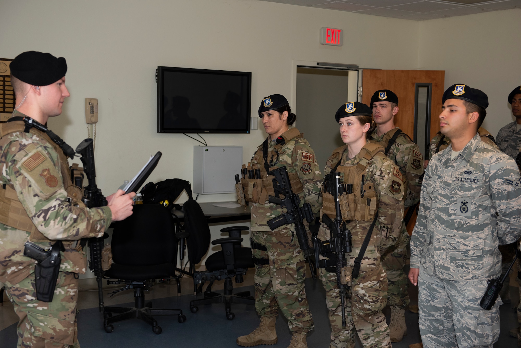 U.S. Air Force Staff Sgt. Dallas Nickerson, left, 60th Security Forces Squadron installation patrolman, briefs members of the 60th SFS at afternoon guardmount June 18, 2019, at Travis Air Force Base, California. Guardmount is a mandatory formation for all security forces Airmen prior to posting out for their shift. The members of the 60th SFS are responsible for protecting resources and personnel for the Air Force’s largest air mobility wing. (U.S. Air Force photo by Tech. Sgt. James Hodgman)