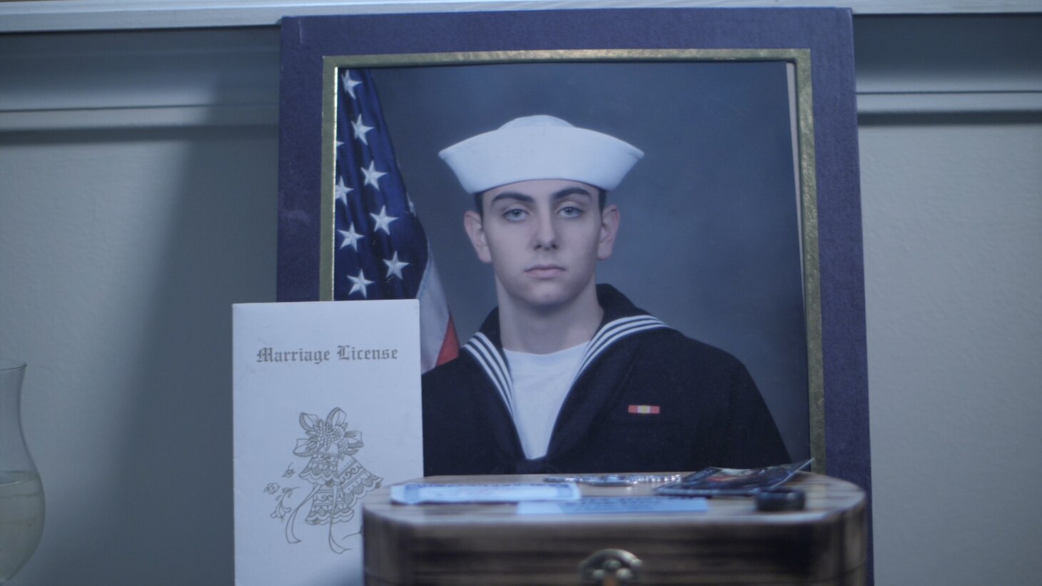 Memorial pamphlet for Aviation Machinists Mate 2nd Class Dakota “Kody” Kinkton is displayed, includes a cover photo of him in dress blues uniform.