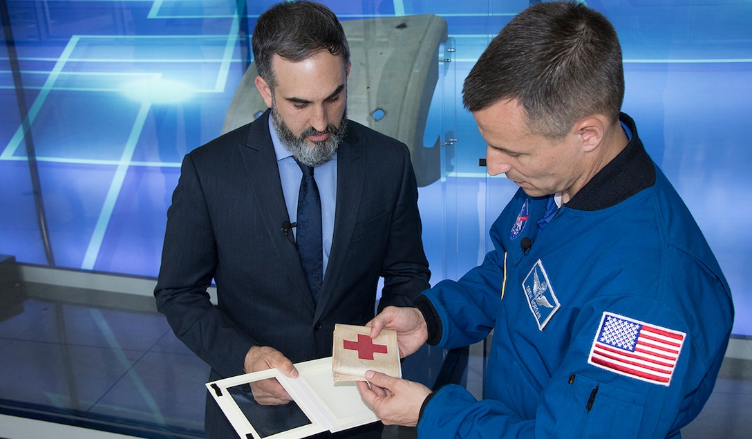 U.S. Army Col. Andrew Morgan receives a combat brassard, a World War II artifact, from Paul Morando, chief, Exhibits Division for the National Museum of the U.S. Army, May 30, 2019. The artifact will be flown to the International Space Station for Morgan's mission and will be returned to the Museum upon his return in Spring 2020. (Courtesy photo Anthony McKinney, Defense Media Activity)