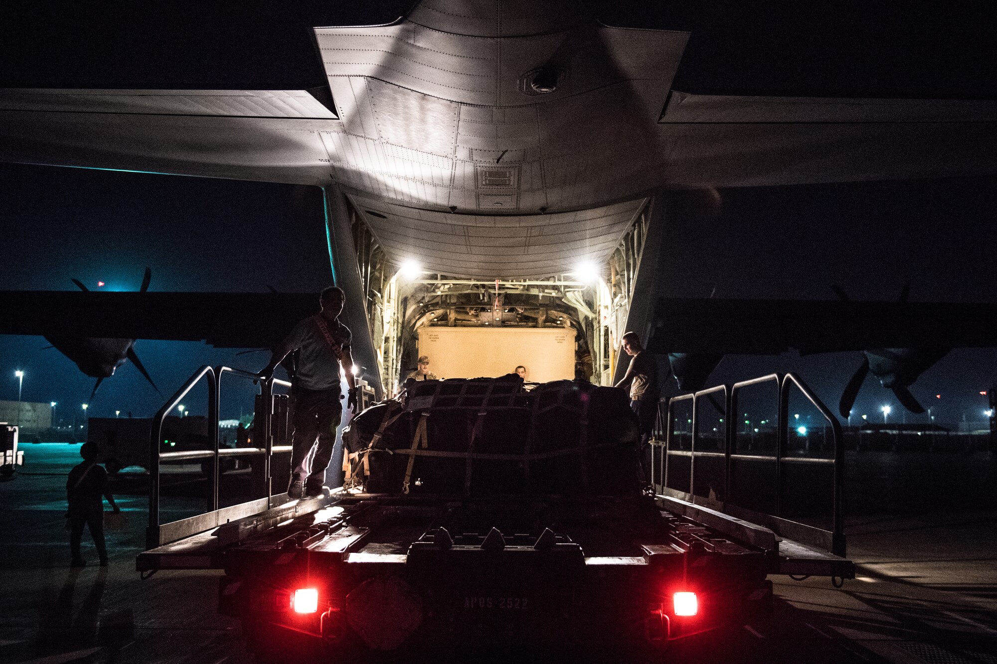 U.S. Air Force Airmen assigned to the 75th Expeditionary Airlift Squadron load luggage onto a C-130J Super Hercules at Camp Lemonnier, Djibouti, June 5, 2019. The 75th EAS provides support in medical evacuations, disaster relief, humanitarian and airdrop operations. (U.S. Air Force photo by Staff Sgt. Devin Boyer)