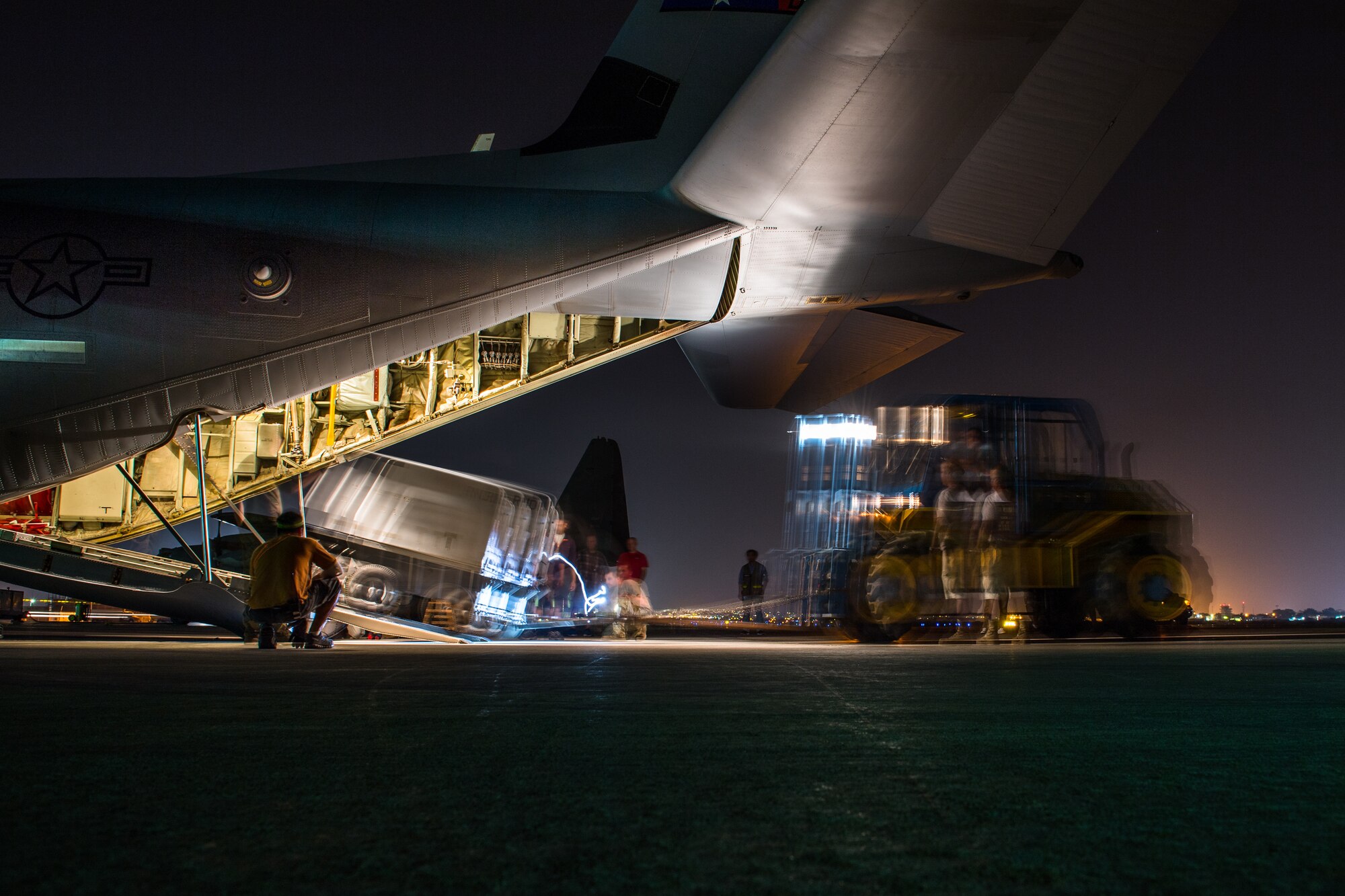 U.S. Air Force Airmen assigned to the 75th Expeditionary Airlift Squadron load a generator onto a C-130J Super Hercules at Camp Lemonnier, Djibouti, June 5, 2019. The 75th EAS provides support in medical evacuations, disaster relief, humanitarian and airdrop operations. (U.S. Air Force photo by Staff Sgt. Devin Boyer)